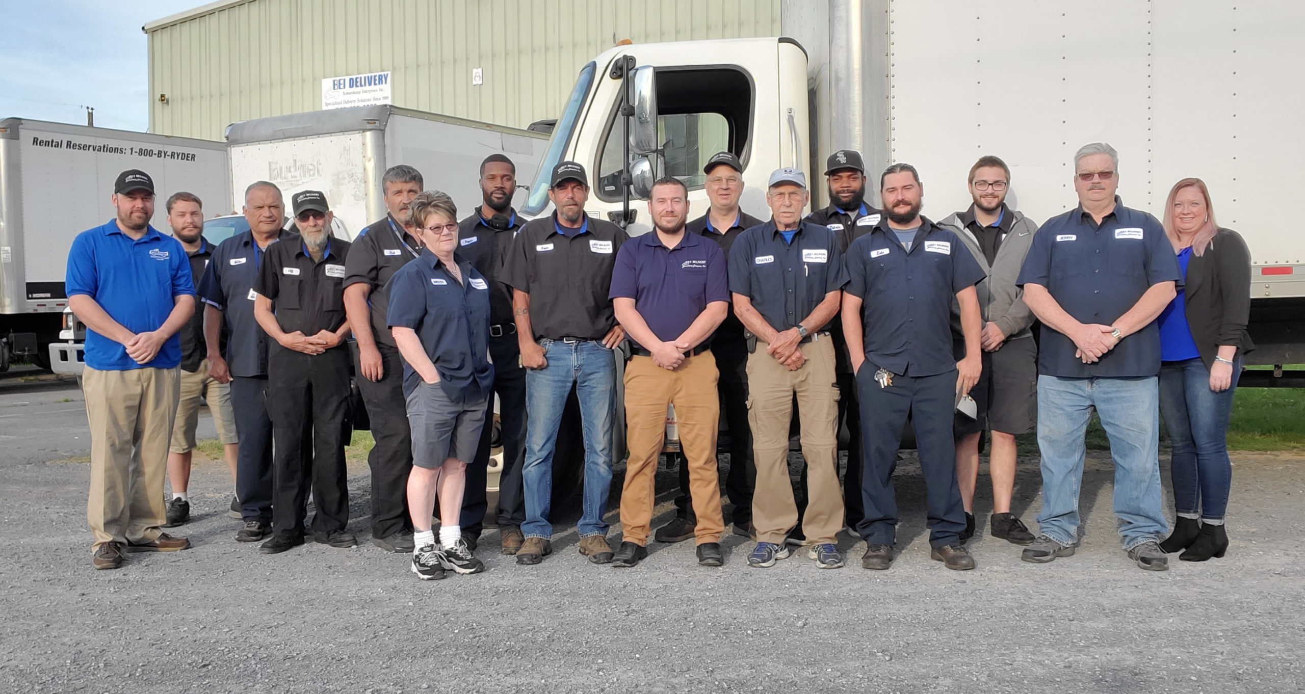 BEI-delivery-team-of-16-people-standing-in-front-of-bei-box-truck-and-warehouse